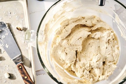 A stand mixer bowl filled with golden toasted marshmallow whipped cream